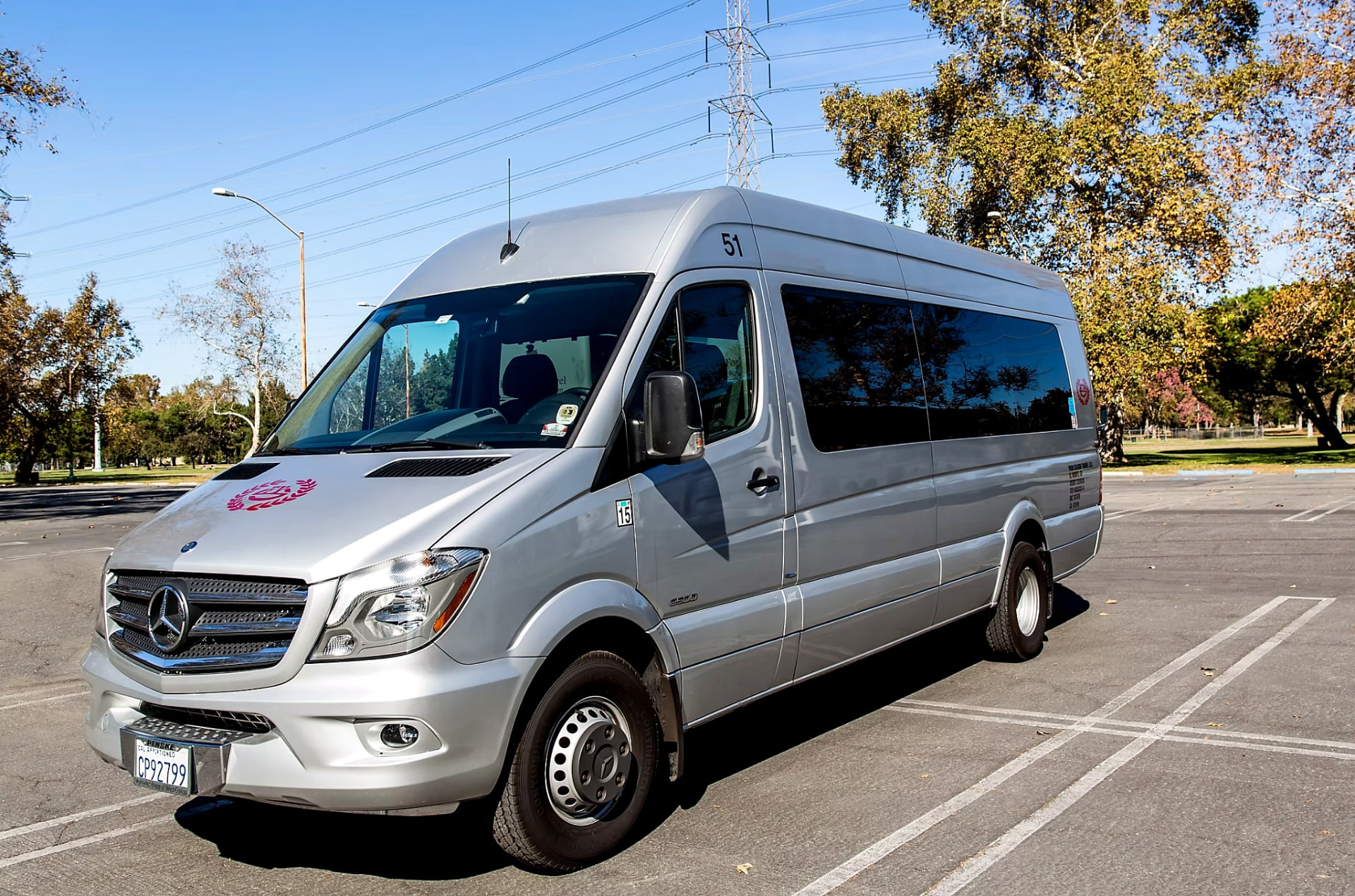 Four Season Travel Mercedes-Benz Sprinter executive van, silver high-roof exterior with the burgundy laurel mark on the hood