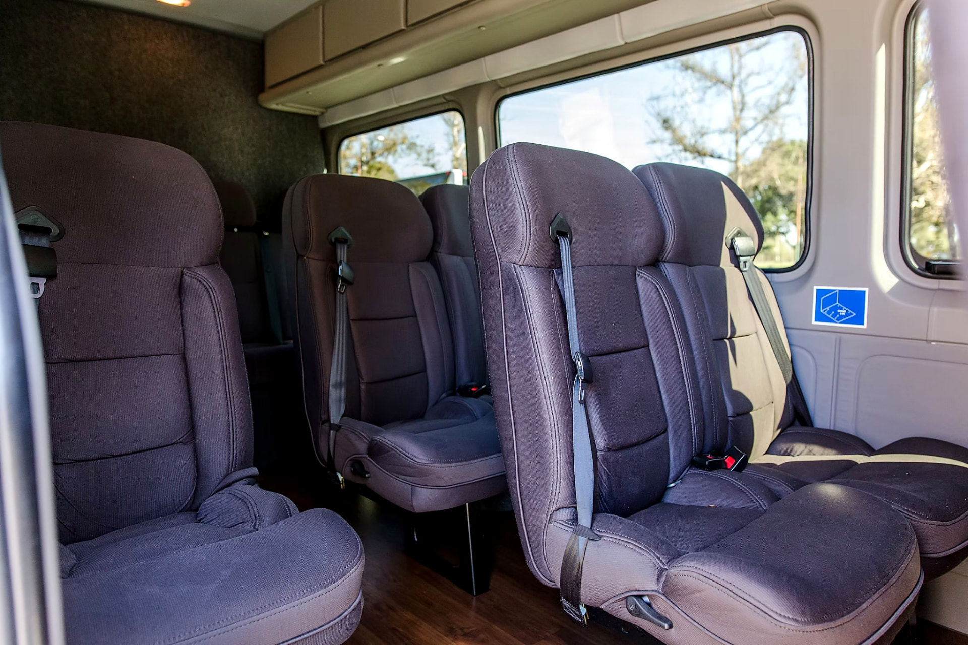 Close view of the cushioned passenger seats and seatbelts inside the Four Season Travel Mercedes-Benz Sprinter