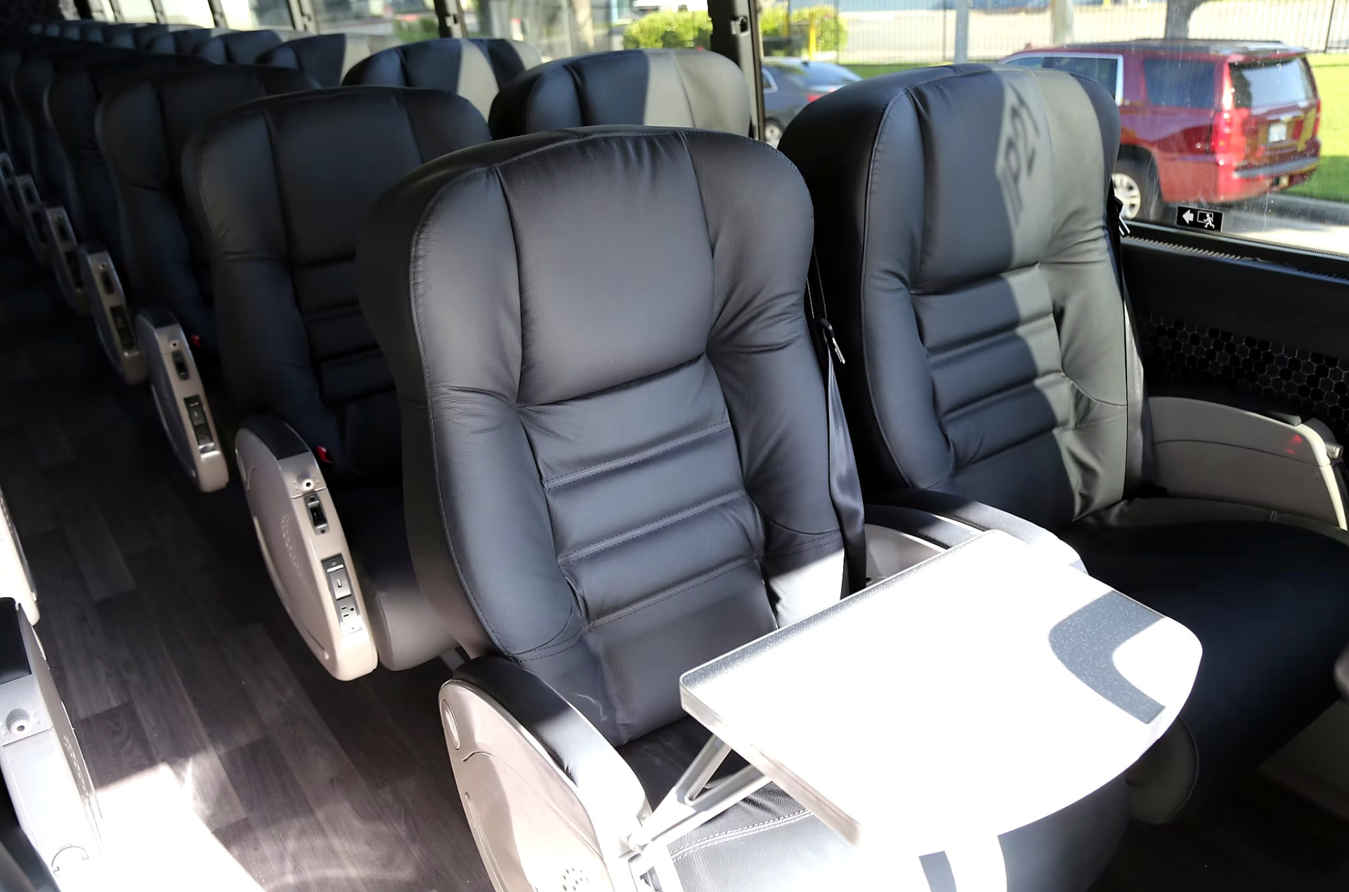 Four Season Travel VIP coach seating with a fold-out work table deployed between seats