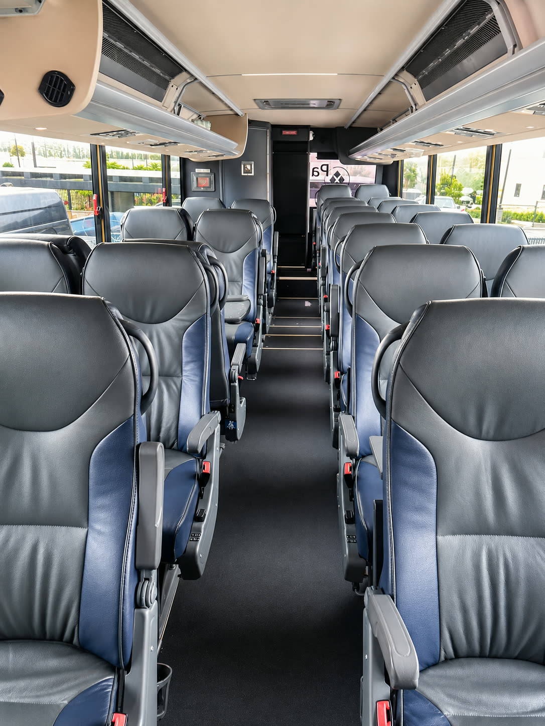Wide interior view down the aisle of the Four Season Travel Mini Coach cabin