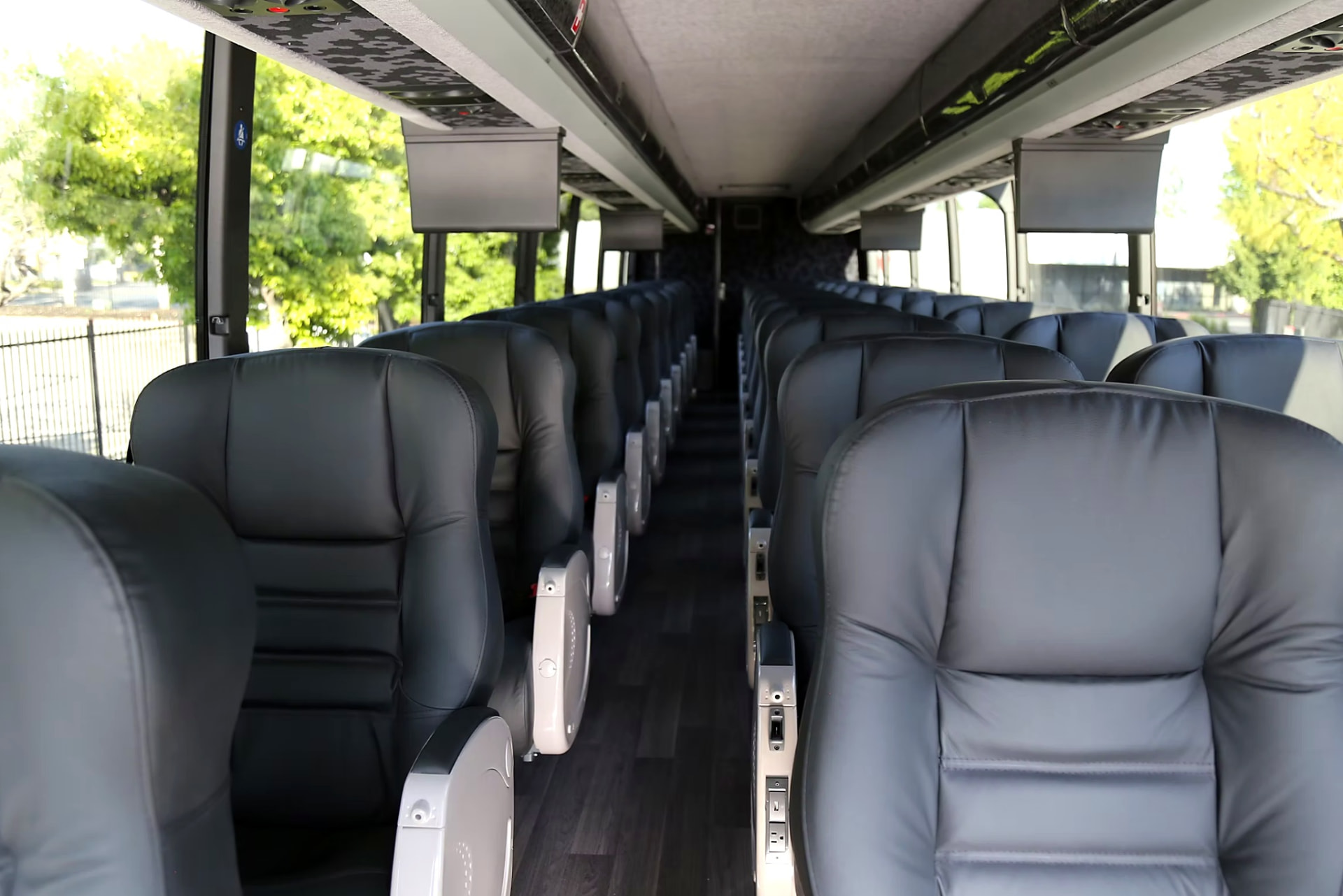 Four Season Travel VIP coach premium passenger interior looking down the aisle at leather reclining seats