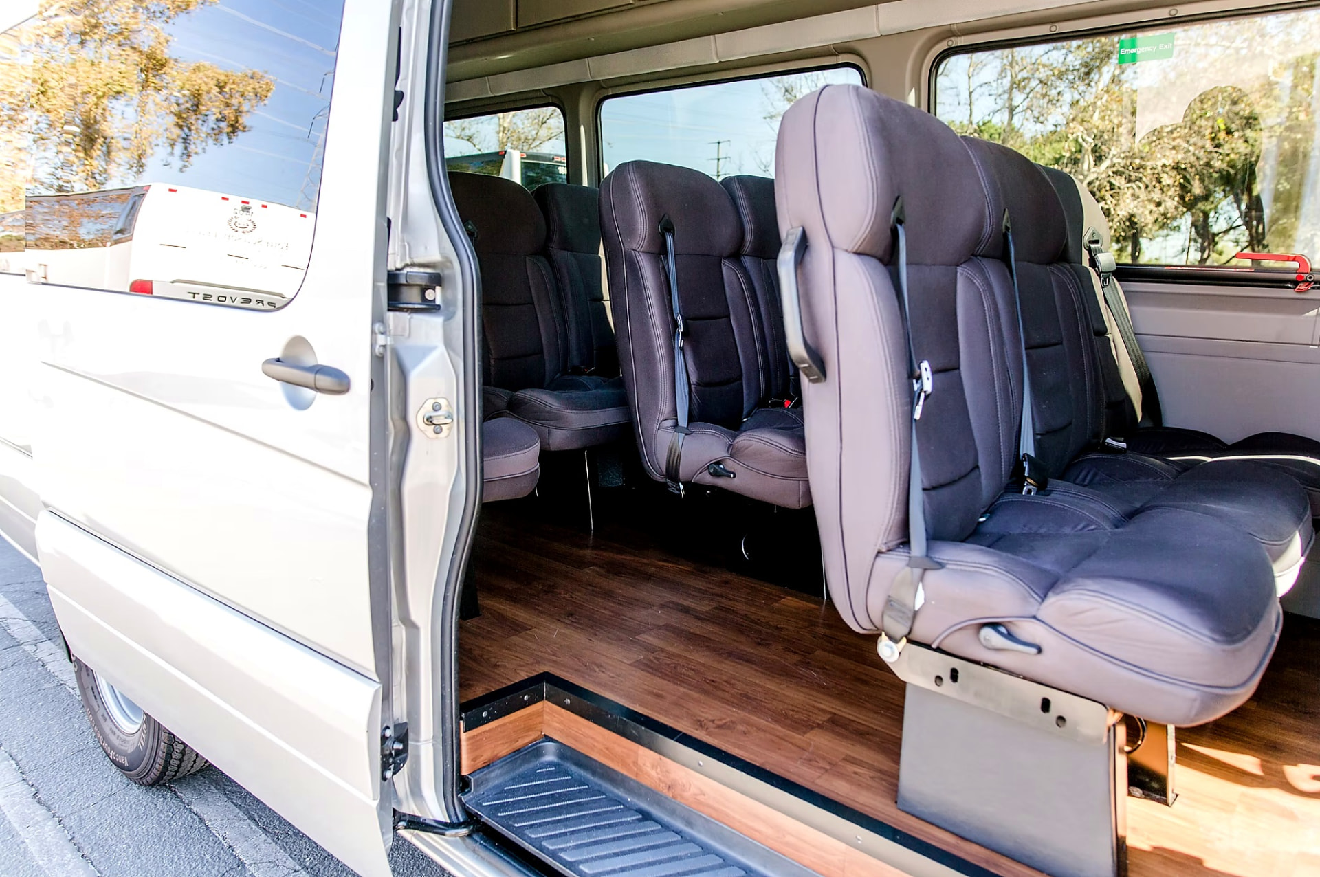 Open passenger door of the Four Season Travel Mercedes-Benz Sprinter showing the entry step and seating rows